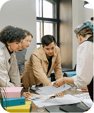 Designers collaborating around a large paper